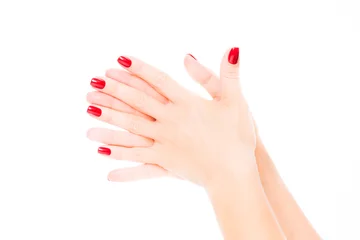 Poster Hands of a young woman with red manicure on nails © EwaStudio