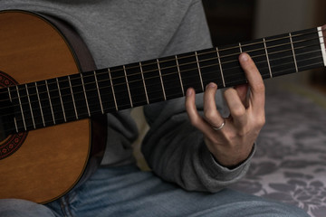 Fototapeta na wymiar classic acustig guitar player performing, focus on hands