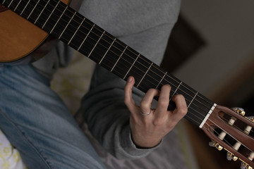 Obraz na płótnie Canvas classic acustig guitar player performing, focus on hands
