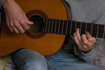 Fototapeta na wymiar classic acustig guitar player performing, focus on hands