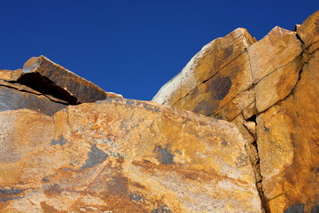 A stone wall against a clear blue sky