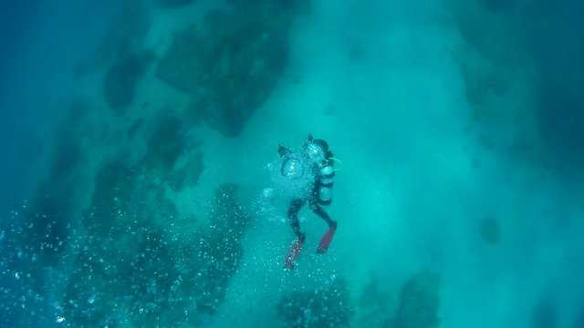 Many bubbles coming up from a scuba diver swimming in the ocean