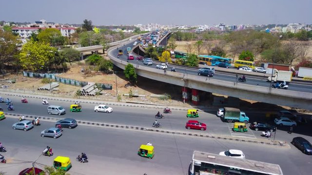 Wide angle panning motion lapse of traffic in KR Puram, Bengaluru, India during day time