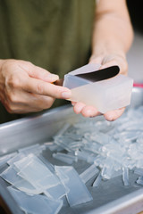 Woman hands cutting a gelatin on a tray.