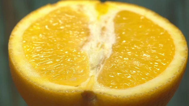 half orange 360 degree torning on a wooden background, tasty healthy food