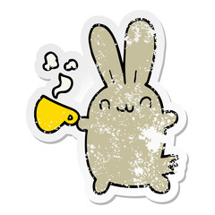 distressed sticker of a cute cartoon rabbit drinking coffee