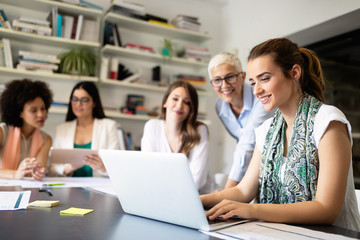 Group of successful business people at work in office