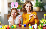 Happy easter! family mother and child with ears hare getting ready for holiday.