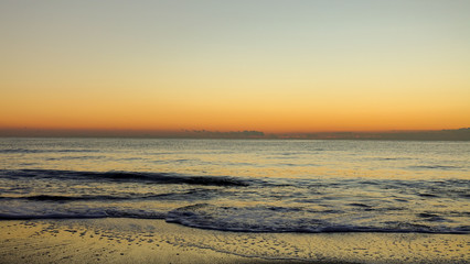 Fototapeta na wymiar A sunrise next to the shore of the mediterranean sea