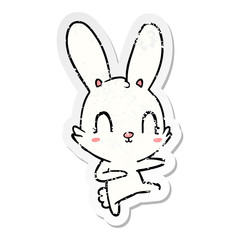 distressed sticker of a cute cartoon rabbit dancing