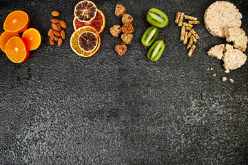 Healthy snacks -  variety oat granola bar,  rice crips, almond,  kiwi, dried orange