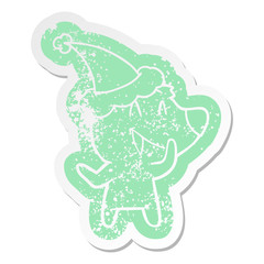 laughing bear cartoon distressed sticker of a wearing santa hat