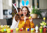 Happy easter! family mother and child with ears hare getting ready for holiday