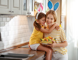 Happy easter! family mother and child daughter with ears hare getting ready for holiday