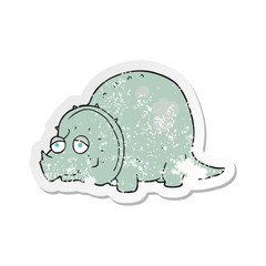 retro distressed sticker of a cartoon dinosaur