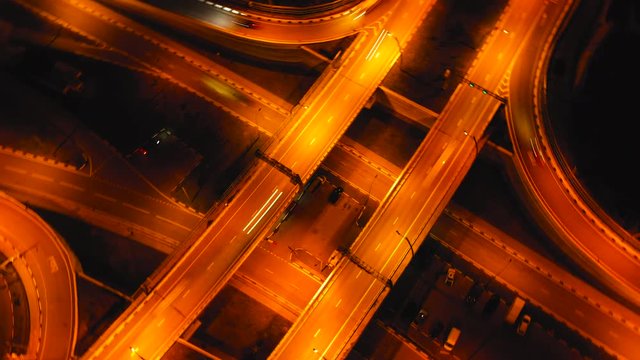 Hyperlapse timelapse of night city traffic on 4-way stop street intersection circle roundabout in Sochi, Russia. 4K UHD aerial view.