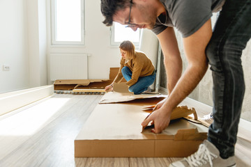 Young man Unpacking new furniture
