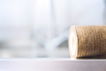 Dirty, brown, used water filter cartridges on background of the sink and tap with water, selective focus