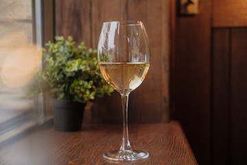 Glass of white wine on wooden table