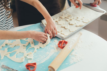 Cutting out cookies from dough on pan