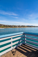 Fototapeta na wymiar A fishing rod on San Clemente Pier in California, on a sunny day