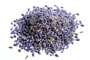 Pile of dry lavender flowers on a white background.