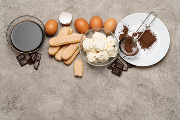 Ingredients for cooking tiramisu - Savoiardi biscuit cookies, mascarpone, cream, sugar, cocoa, coffee and egg