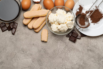 Ingredients for cooking tiramisu - Savoiardi biscuit cookies, mascarpone, cream, sugar, cocoa, coffee and egg
