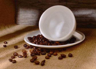 White cup of coffee with coffee beans.