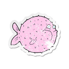 retro distressed sticker of a cartoon puffer fish