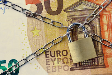 Closeup of 50 euro banknote locked with chain and padlock - Concept of insurance, bail-in and...