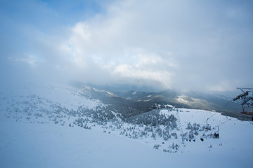 Fototapeta na wymiar ski lift in the snowy mountains