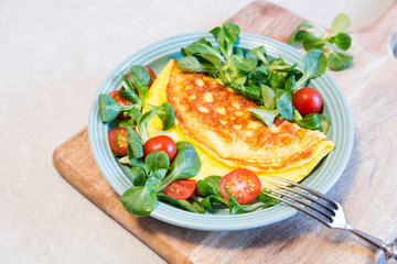 Homemade omelette with salad on plate. Healthy food concept