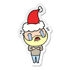 sticker cartoon of a bearded man crying wearing santa hat