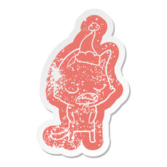 talking cat cartoon distressed sticker of a wearing santa hat
