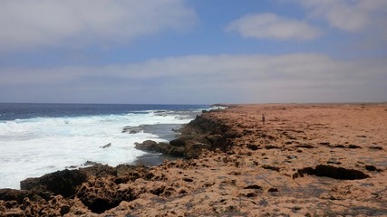 View of the coastline along the blowholes, located in the vicinity of Point Quobba, Western Australia. This natural phenomenon happens when powerful ocean swells force water through the sea caves .