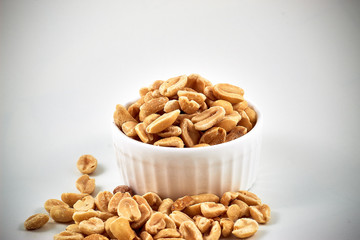 Roasted peanuts on a white background.