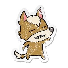 distressed sticker of a cartoon wolf waving showing teeth