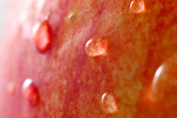 red apple with water drops macro shot