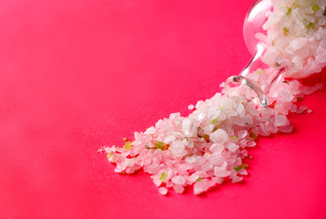 Obraz premium White sea salt is poured from a glass bottle.