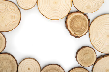 Pine tree cross-sections with annual rings on white background. Lumber piece close-up shot, top view.
