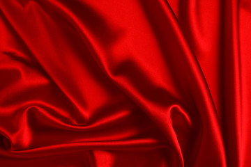 Red silk or satin luxury fabric texture can use as abstract background. Top view.