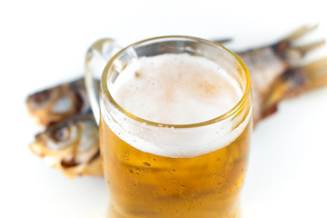 Traditional russian snack. A glass of beer and dried fish. White background.
