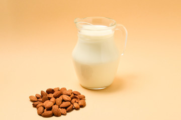 A jar with almond milk, nuts. Space for text or design.