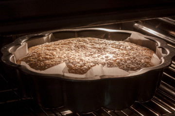 Sweet donut with sugar grains in the oven, cooking process