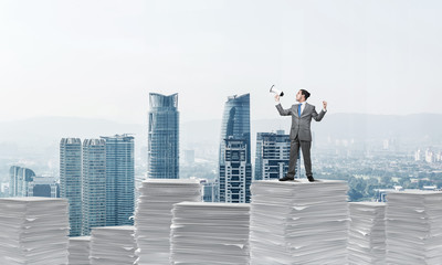 Businessman standing with megaphone.