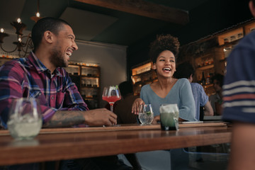 Friends having fun over drinks together in a bar