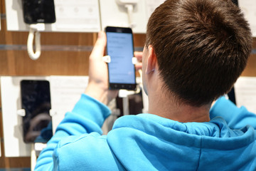 Seller consultant photographs goods on a smartphone