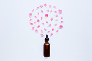 Bottle of rose essential oil for aromatherapy on white