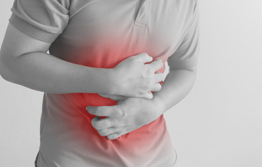 asian man suffering from stomachache.  Concept with Health care And Medicine.